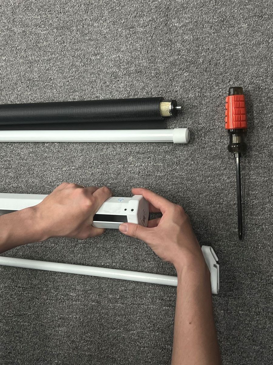 A human arms are hold the projector screen case
