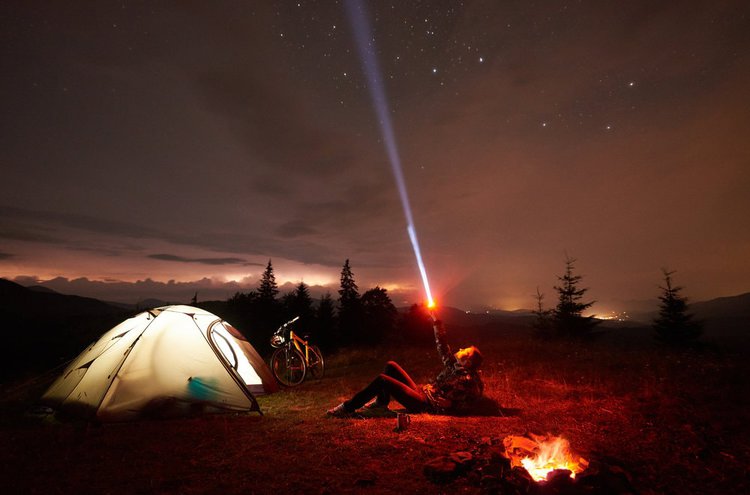 young woman using a laser pointer to point stars