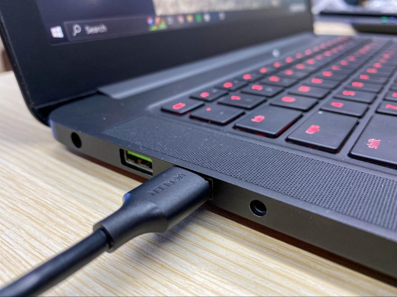 a USB-A port connector is plugged into a USB port on the laptop