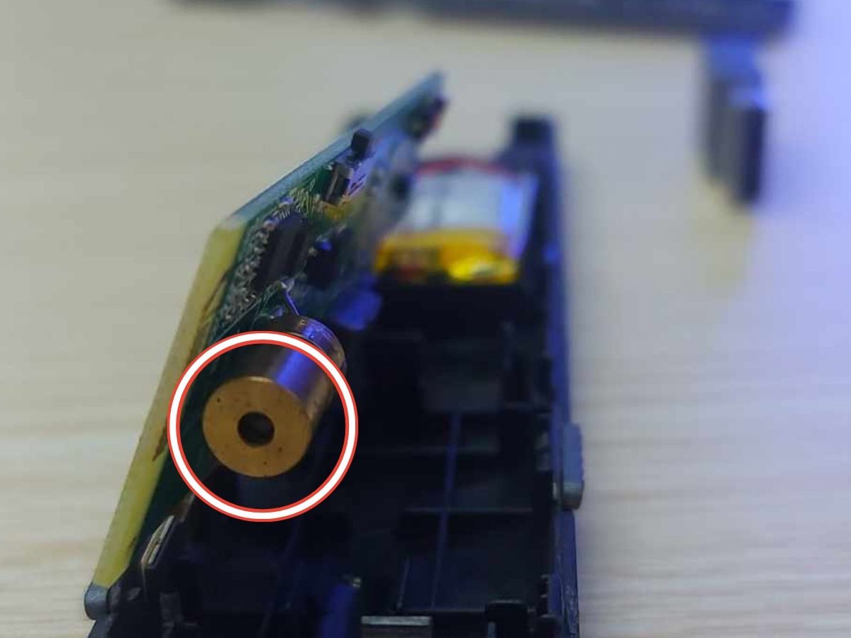 The lens locates under the motherboard of the laser pointer
