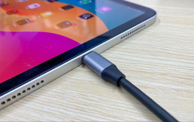 a USB-C connector is connected to an iPad