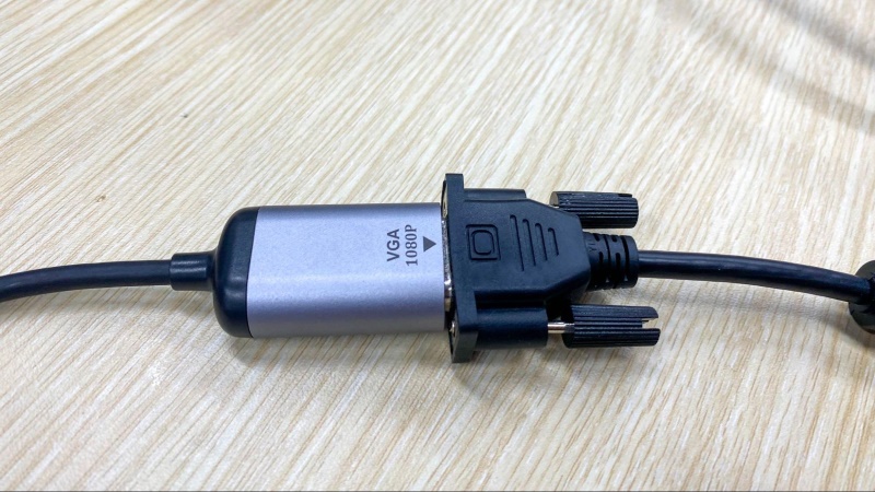 a VGA connector is connecting to a USB-C to VGA converter