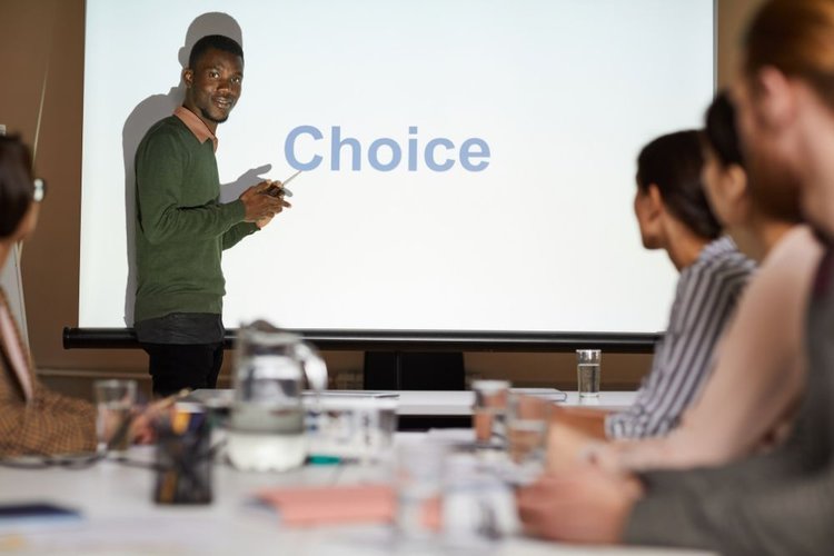 a black man giving a presentation in Powerpoint presenter mode