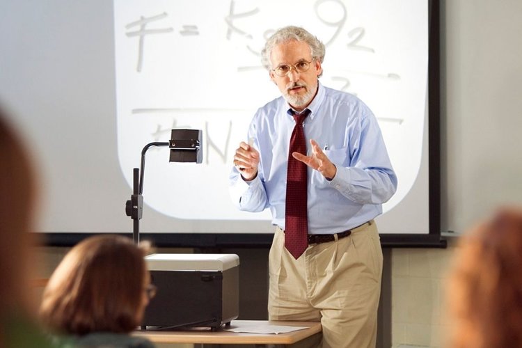 a teacher using an overhead projector in the classroom