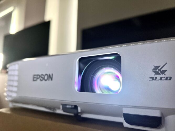 epson projector is shining blue and look from right rear