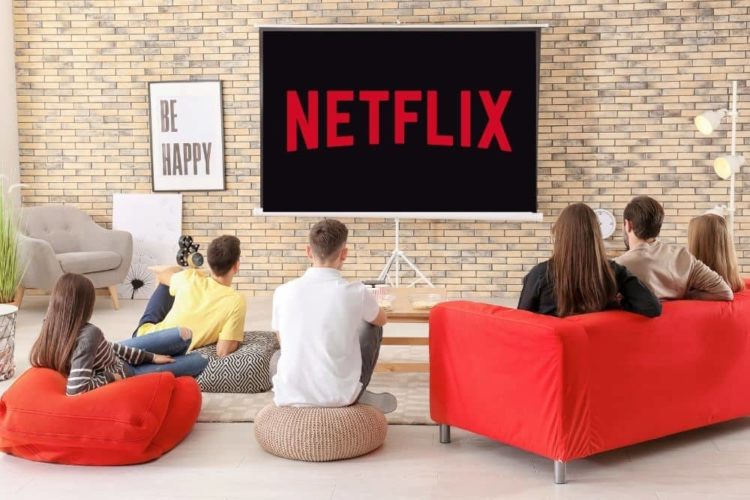 a group of friends watching netflix with a projector