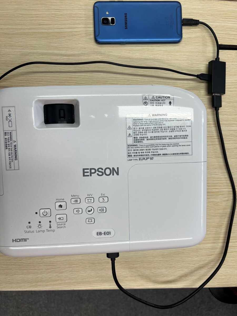 Samsung Galaxy A6 is connected to a Micro USB adapter with the HDMI cable is connected to the Epson projector