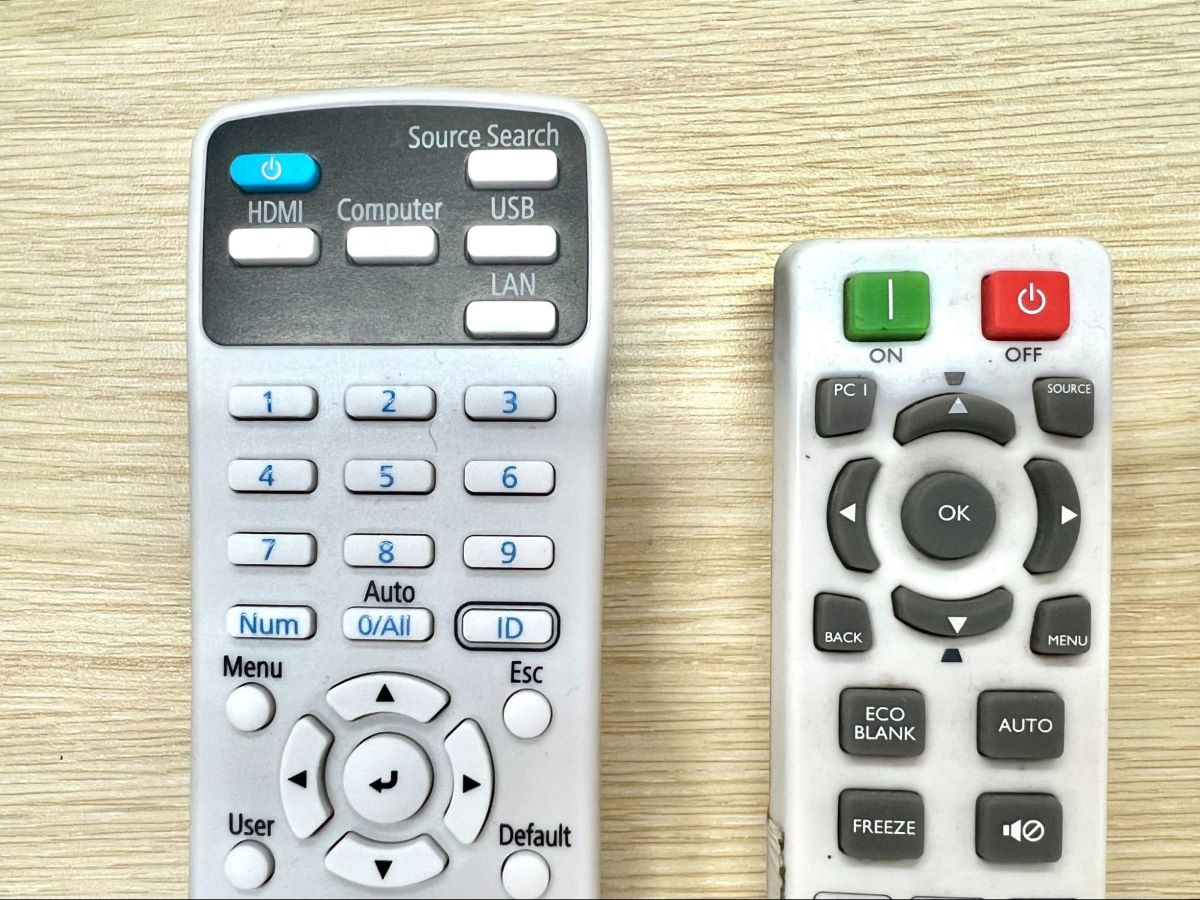 epson and benq remotes next to each other