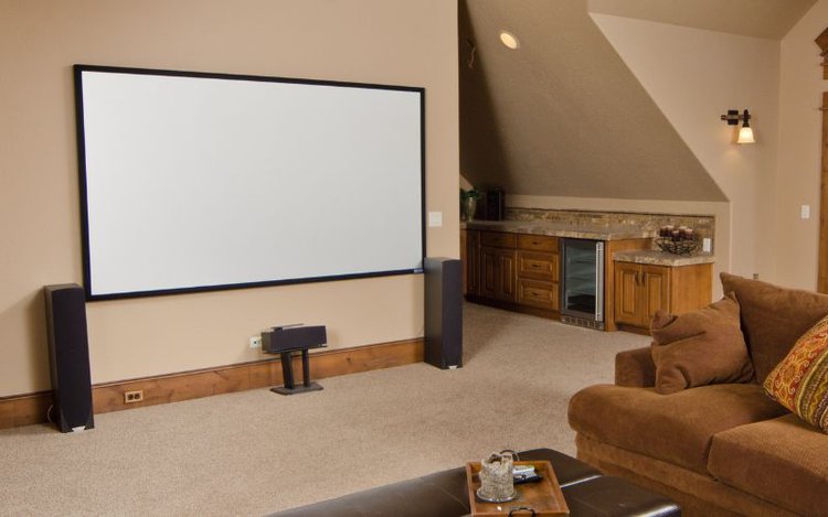 home theater setup with projector and two external speakers