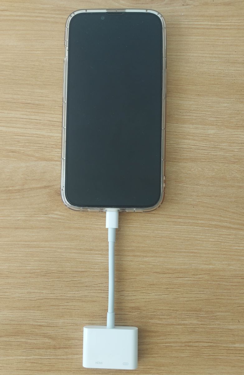 iPhone 13 Pro Max is connected with a lightning to digital AV adapter