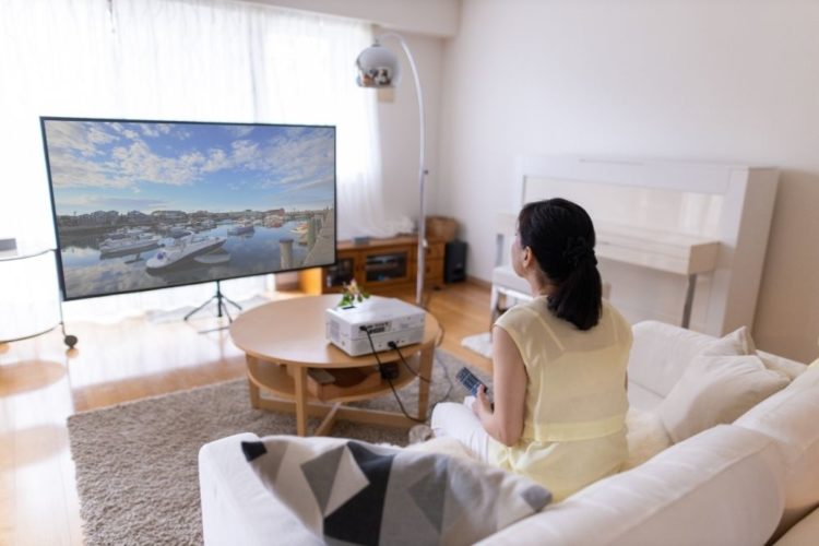 woman sitting at a appropriate distance from projector screen