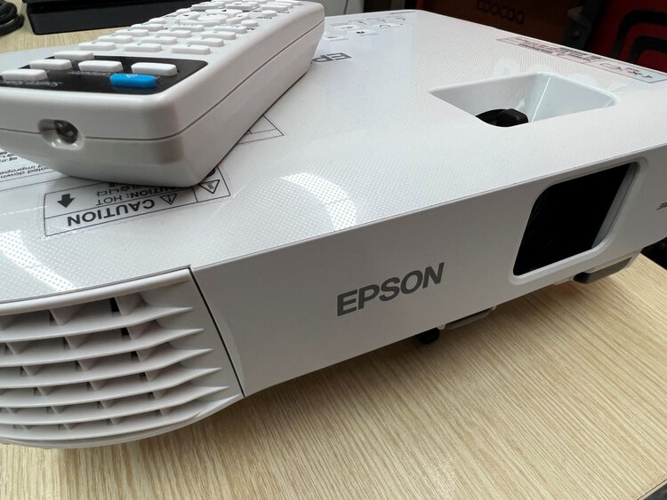 Epson projector with the remote on top of it