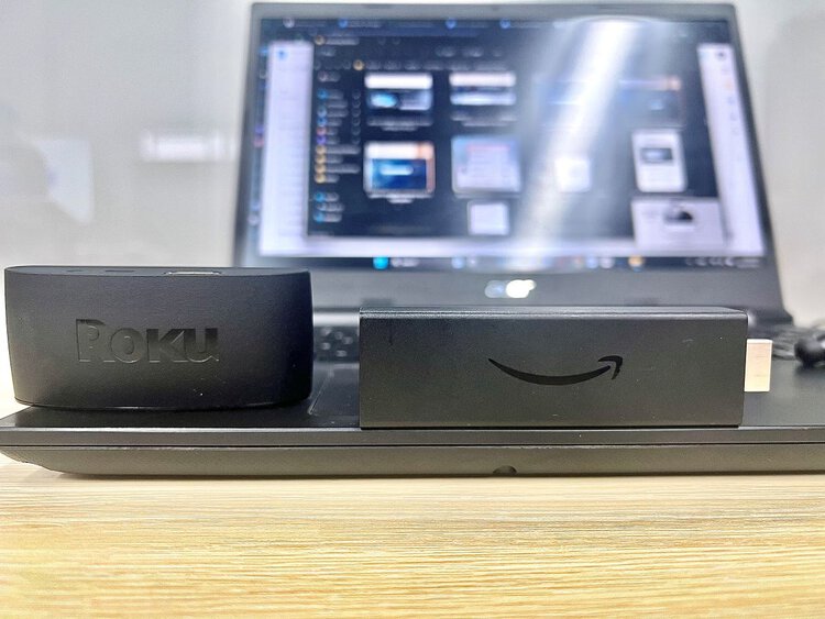 a roku and a firestick are on an acer laptop
