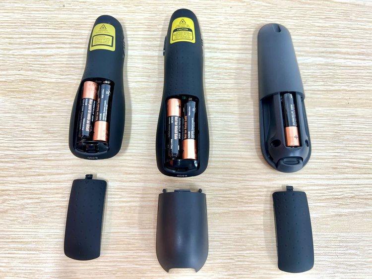 3 laser pointers with their battery compartments opened