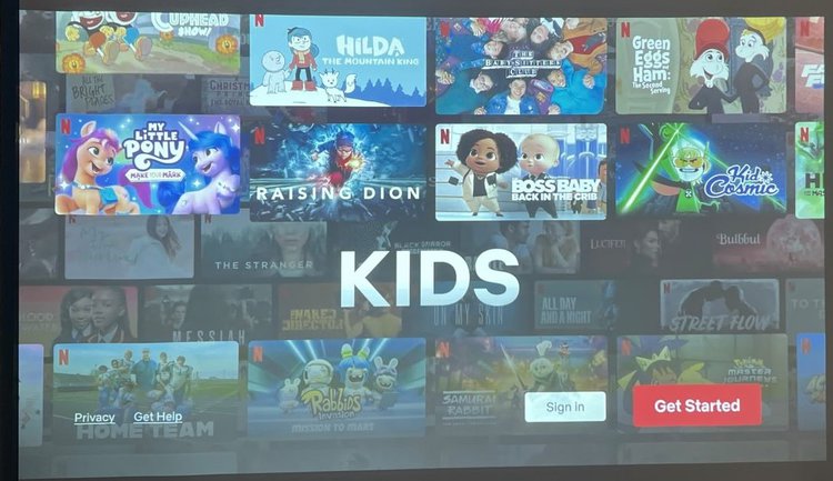 The kids’category on Netflix is being displayed on a projector screen.