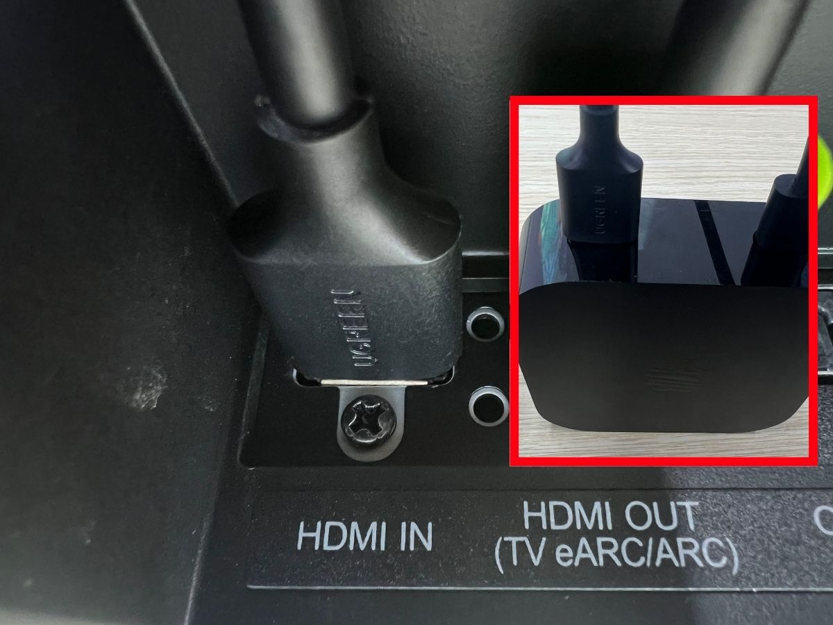 An HDMI cable is plugged to the HDMI INPUT on soundbar Apple TV box