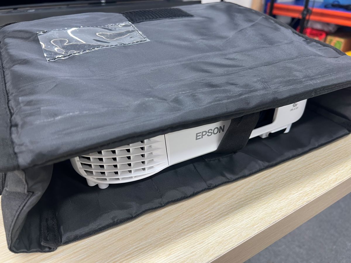 Epson projector is in a bag and on a wooden table