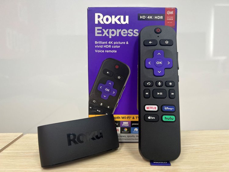 Roku player with remote with its box and white background
