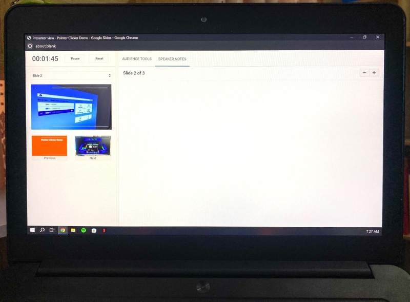 a laptop screen is displaying Google Slides Presenter View mode