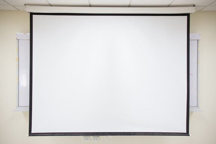 a screen pulled down in front of a white board