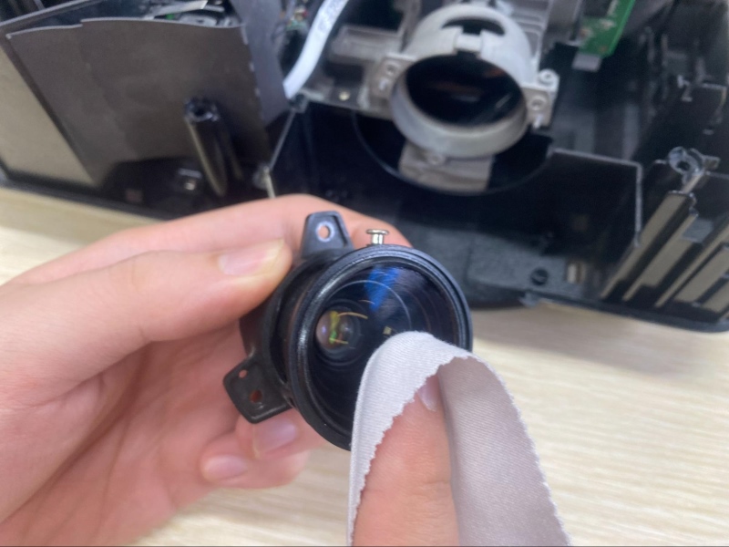 use a microfiber cloth to clean the projector lens