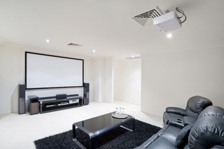 a home theater with projector on the ceiling