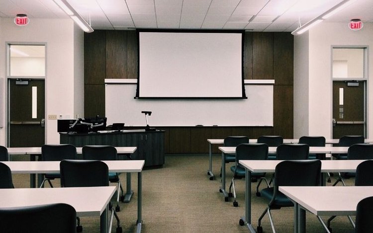 a classroom with a motorized projector screen