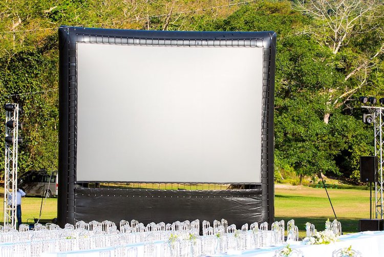 an inflatable outdoor screen in a garden