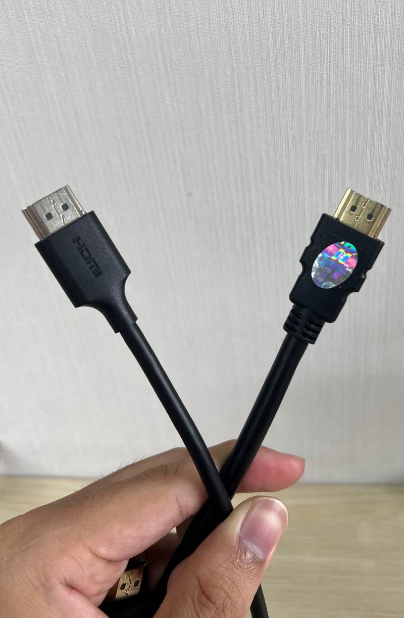 2 HDMI cables on a hand