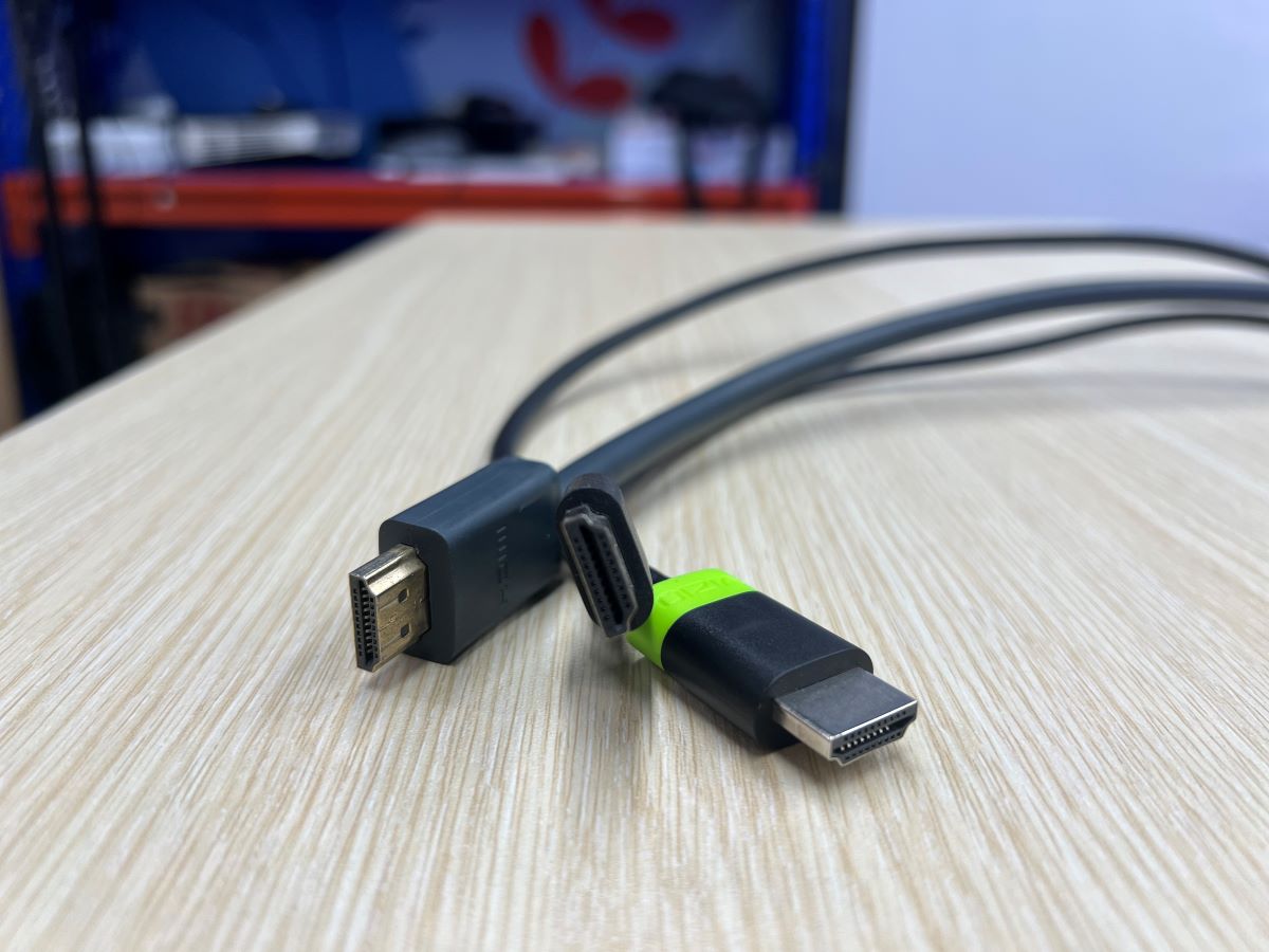 Many HDMI cables with different size of the connector are on a wooden table