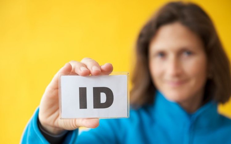 a woman showing a ID card as required