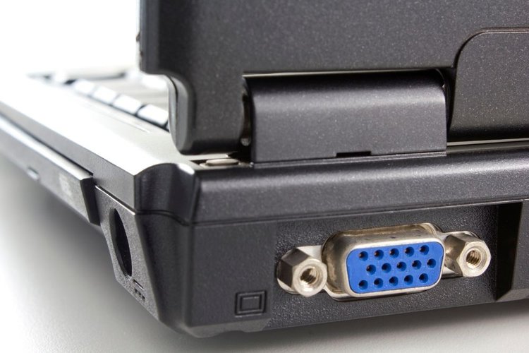 A VGA port in the back of a white laptop
