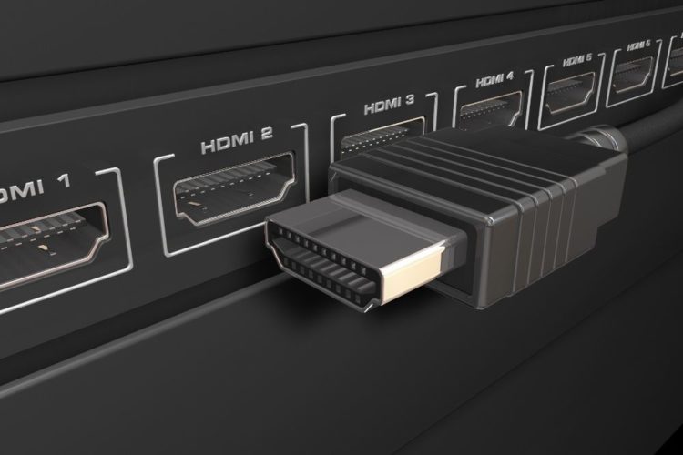 A black hdmi cable next to black hdmi ports