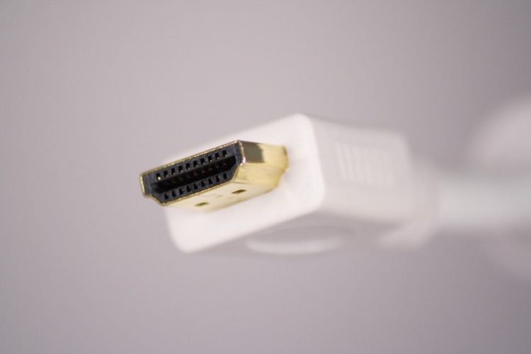 A white hdmi cable in front of a white wall