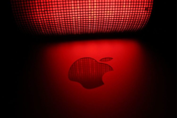 An apple Logo under red light