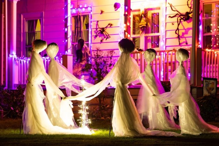 Halloween decor in front of a white house