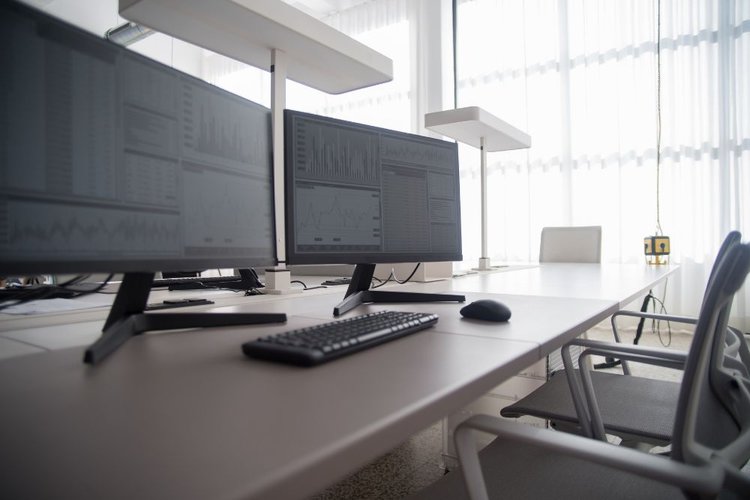 Two black monitors in an office