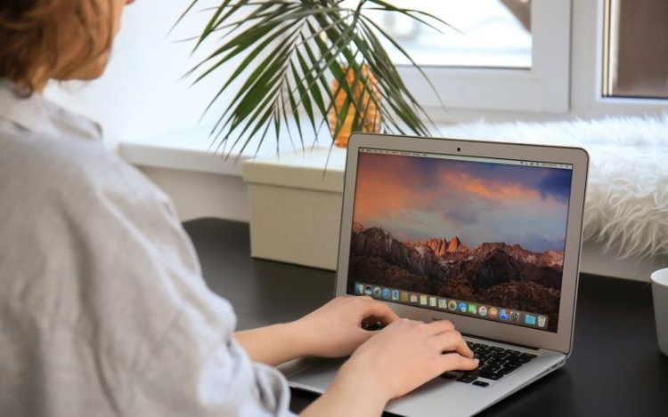 Woman working with Mac Laptop