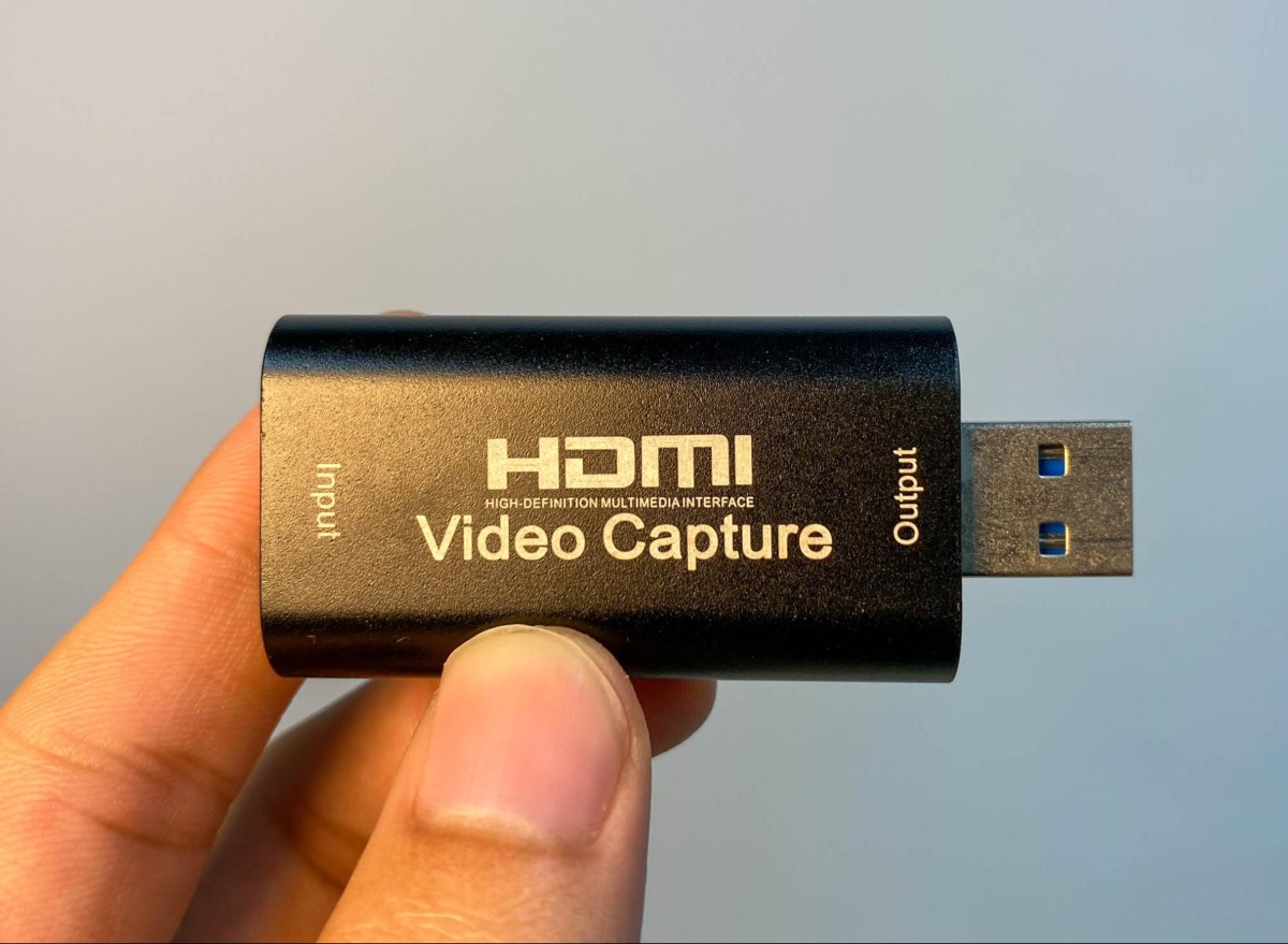 a HDMI video capture card on a hand
