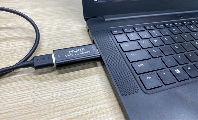 a video capture card is connected to a USB port on a laptop