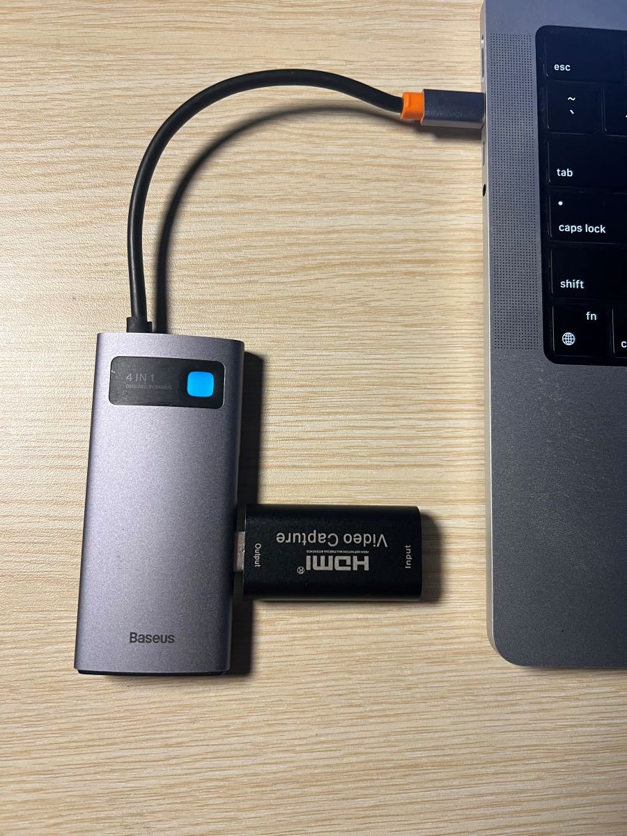 an HDMI capture card is plugged to the USB-C hub and the hub is plugged to the MacBook via USB-C port