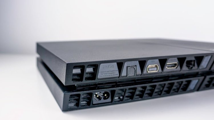 the back of a ps4 with hdmi usb ports
