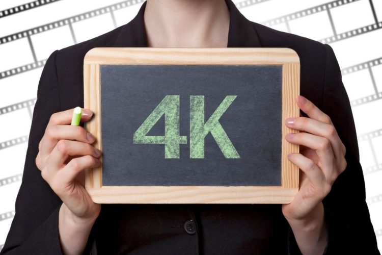 A woman holding a 4K board