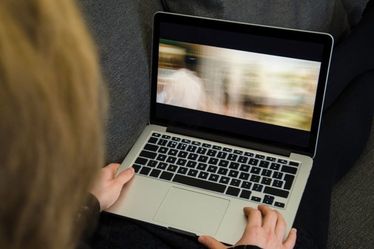 A women watching film on a laptop