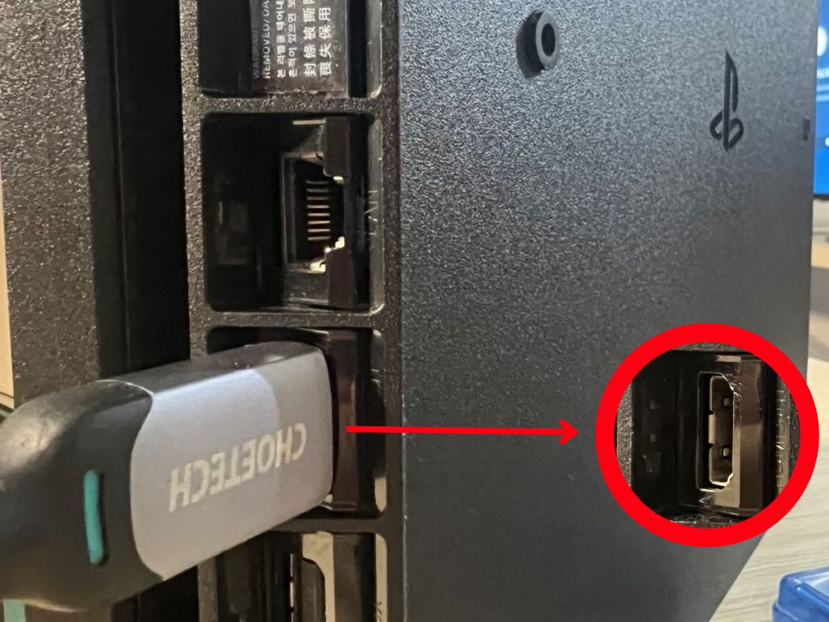 An HDMI cable is plugged to the HDMI port behind of the PS4 console