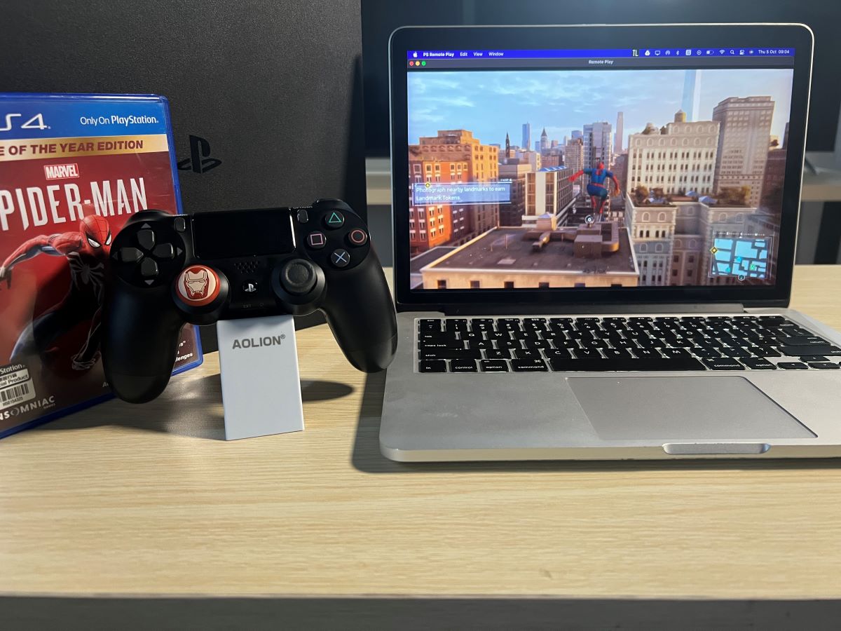 MacBook Pro 2013 is playing Spider-Man game via the PS4 console with the PS control along side