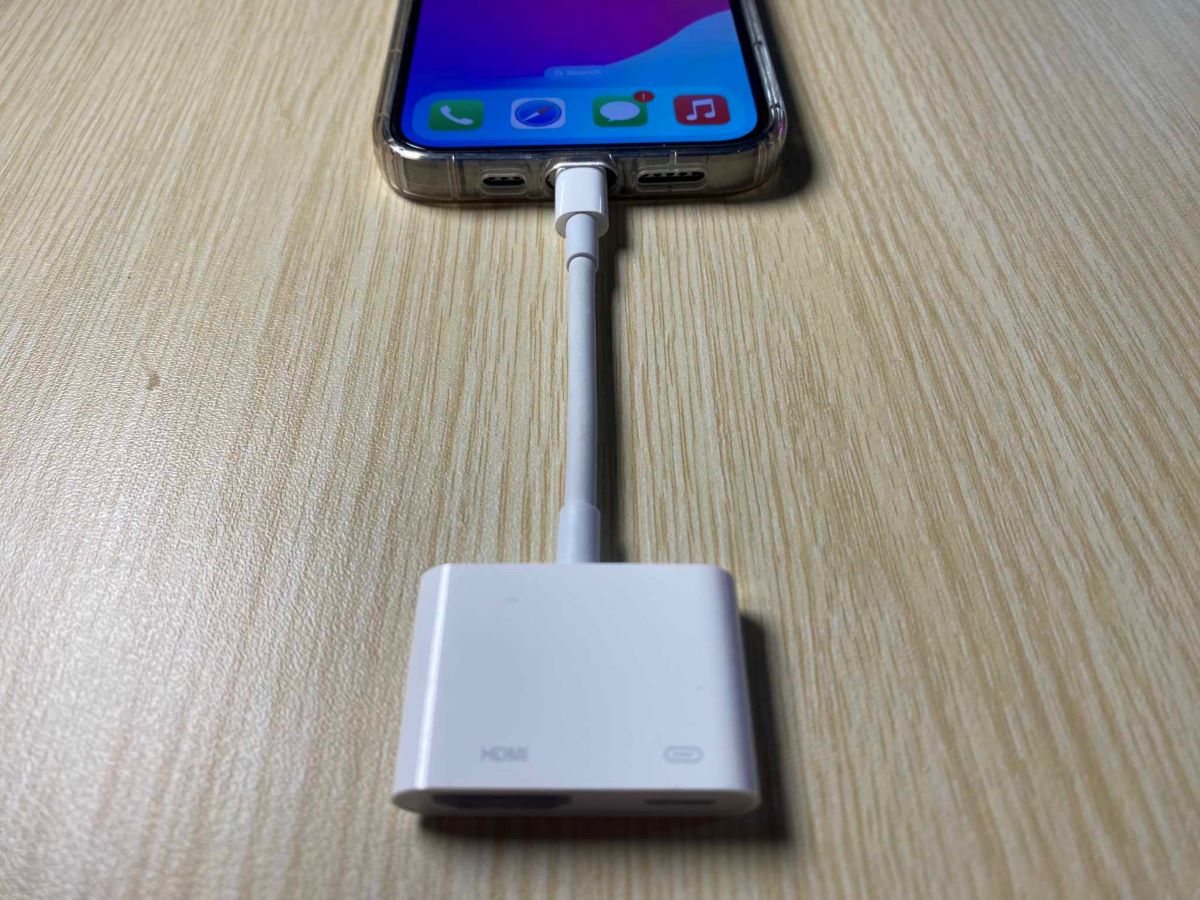 The iPhone 13 Pro is connected to the Lightning to HDMI adapter