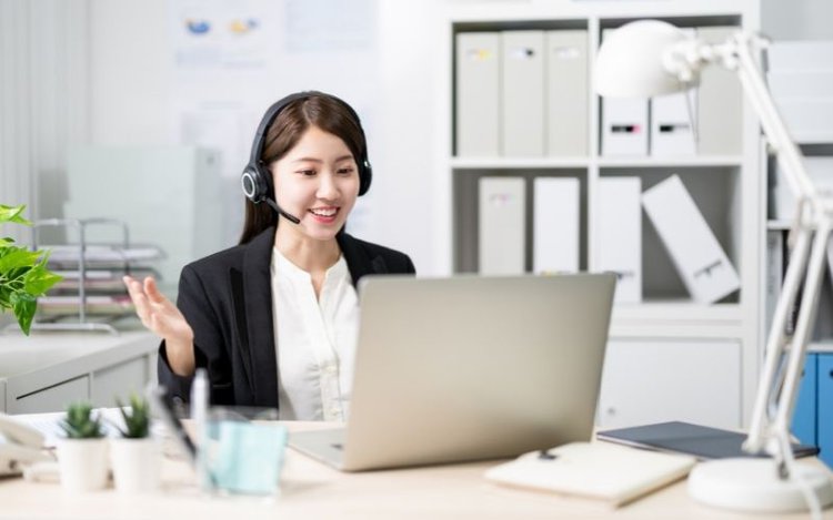 Woman smiling while making online presentation