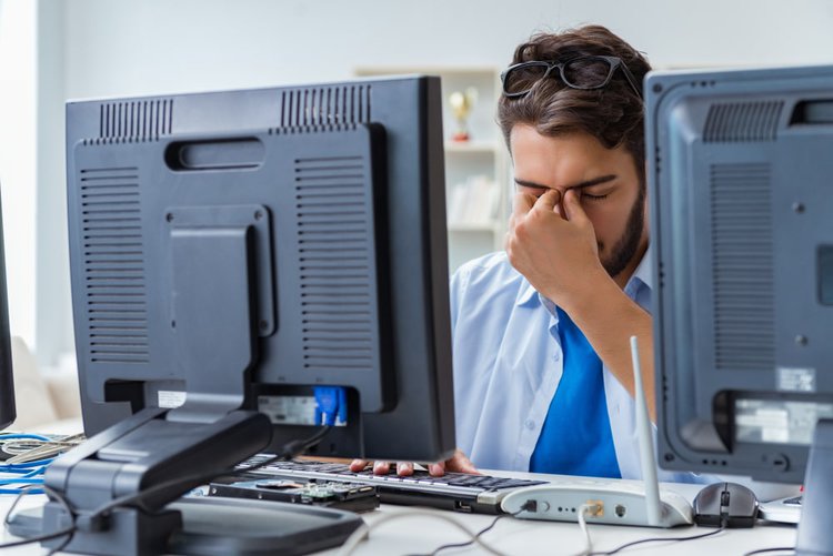 a guy headache with a black screen monitor