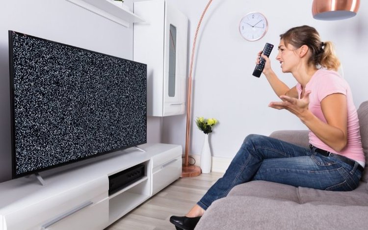 a woman angry at TV flickering